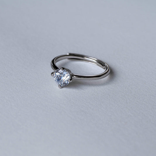 "Sparkling silver ring with embedded solitaire - exquisite craftsmanship and brilliance"